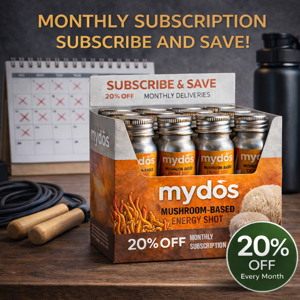 Mydos mushroom-based energy shot case on a desk with a calendar, jump rope, water bottle, and a 20% off monthly delivery subscription badge.