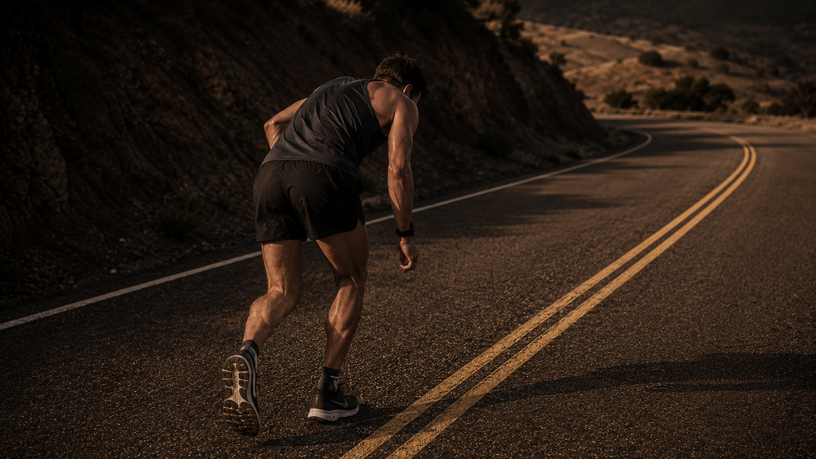 Runner experiencing the onset of hitting the wall running at mile 20, posture collapsing as pace fails